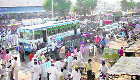 Irked by the slow pace of purchases, farmers block traffic outside the grain market in Fatehabad on Wednesday.