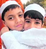Two Kashmiri boys hug each other after Eid-ul-Fitr prayers in Srinagar