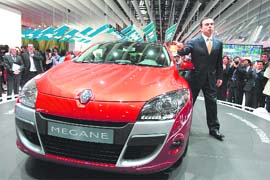 French auto group Renault's chairman Carlos Ghosn poses in front of a new Coupe Megane at a press conference at the Paris Motor Show on Thursday. The show opened on Thursday for the press and industry representatives. From Saturday until October 19 it will be open to the public. 
