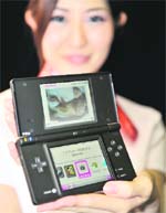 Japanese video game giant Nintendo unveils new portable video game console, the "DSi", equipped with a 3.25-inch LCD display and 300,000-pixel digital camera on its handheld body, at the annunal Nintendo conference in Tokyo on Thursday. The dual-screen machine will go on sale in Japan from November 1.