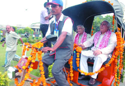 Delhi Chief Minister Sheila Dikshit and union minister of science and technology Kapil Sibal ride on a solar-electric rickshaw  Soleckshaw, in New Delhi on Thursday.