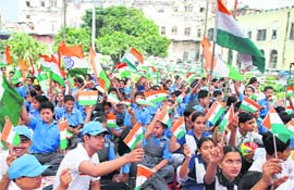 Children hold aloft the Tricolour on the occasion of Gandhi Jayanti.