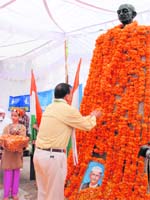 A Congress leader pays floral tributes to Mahatma Gandhi at Mubarak Mandi in Jammu on Thursday.
