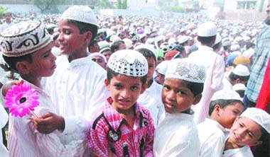 Little boys greet each other at a mosque to celebrate Eid in Jalandhar