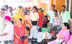 People wait at the sub-registrar office in Ludhiana
