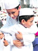 Two boys hug each other after Eid-ul-Fitr prayers at a mosque in Patiala