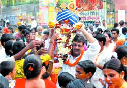 A person carries deity Subadhra during the Jagannath Rath Yatra organsied by Sri Raman Vihari Goudiya Math at Karol Bagh in New Delhi 