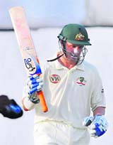 Australia's Mike Hussey raises his bat after completing his half century against Board Presidents XI on the second day of the four-day warm-up match in Hyderabad