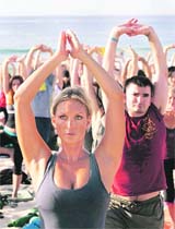 Yoga enthusiasts perform at an open air class at Bondi beach in Sydney 
