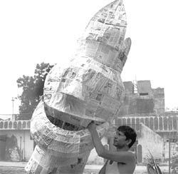 An artist gives final touches to an effigy of Ravana ahead of Dasehra in Ambala on Saturday.