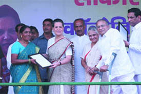 UPA Chairperson Sonia Gandhi, Delhi CM Sheila Dikshit and DPCC president JP Agarwal, distribute provisional certificates to residents of unauthorised colonies at Chhatrasal Stadium in New Delhi on Saturday.