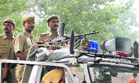 Police personnel stand guard during the hearing of the case relating to the Dera Sacha Sauda chief in Ambala on Saturday.