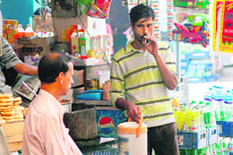 Despite a ban imposed on smoking in public places, a man smokes inside the inter-state bus terminal in Jammu on Saturday.