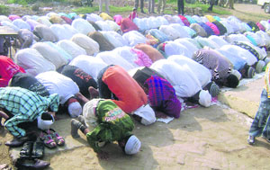 Muslims offer prayers on the road in front of Idgah in Ahmedgarh. 