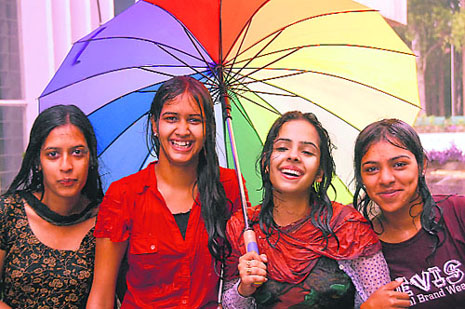 Girls make the most of the shower that lashed the city on Saturday.