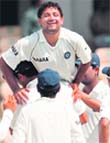 Board President's XI cricketer Piyush Chawla is lifted up by captain Yuvraj Singh after taking the wicket of unseen Australian cricketer Peter Siddle on the third day of the four-day practice match between an Indian Board President's XI and Australia in Hyderabad 