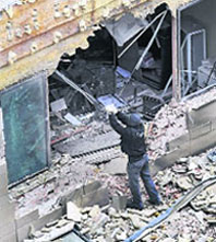 A police officer works in the rubble at the City Court building where a bomb exploded in the Basque town of Tolosa, northern Spain, on Saturday.