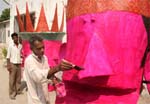 An artist giving final touches to the effigy of Ravana in Bathinda