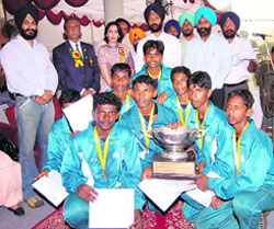 The Kerala team receive the trophy from Punjab PWD minister Parminder Singh Dhindsa on the concluding day of Junior National Cycle Polo Championship at Polo Ground in Patiala on Sunday. 