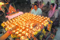Devotees light 121 diyas at a temple in view of the Navratras in Amritsar