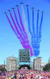 The Royal Air Force display team, Red Arrows, fly over as competitors cross the Tyne Bridge during the Great North Run in Newcastle, England, on Sunday. 