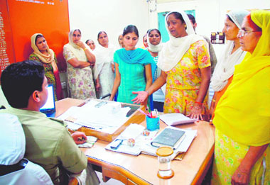 Aggrieved members of the family of deceased Mangat Singh meet DSP S.S. Bhoria in Karnal on Monday.