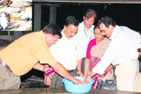 Dr Mohan Joseph Modayil interacts with fish farmer Sultan Singh of Bhutana village on Monday.