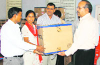Principal of Dronacharya Government College C.R. Mor gives a computer to a girl student on Monday.