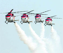 Advanced Light Helicopters of the IAFs Sarang aerobatics team perform during the full dress rehearsal for Air Force Day at the Air Force Station, Hindon, in Ghaziabad on Monday.