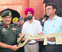 GOC, Panther Division, Major-Gen P.S. Paul, hands over the key of the Gobindgarh Fort to special secretary, Tourism, D.P. Reddy (right) and DC Kahan Singh Pannu (centre) in Amritsar on Monday.