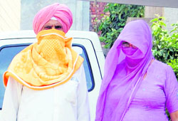 The NRI couple, who were detained for possessing heroin, being taken to court in Amritsar on Monday. 