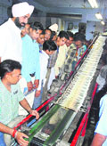 Punjab finance minister Manpreet Singh Badal along with schoolchildren at the Tribune press on Tuesday.
