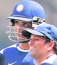 Sachin Tendulkar speaks with Sourav Ganguly during a practice session in Bangalore on Tuesday. Former India captain Ganguly announced that he will retire after the Test series against Australia that starts this week.