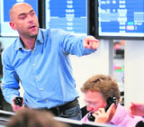 Brokers react to news of a 0.5 per cent cut in the interest rate from The Bank of England, in London on Wednesday.