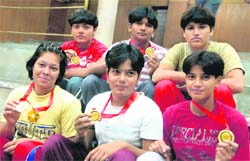 Jubilant wrestlers of GGS College for Women with their medals in Chandigarh 