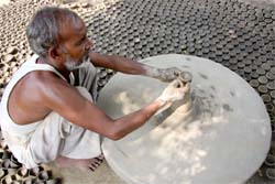 Nikku Ram works on the potters wheel preparing diyas