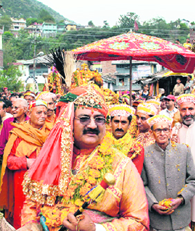 Devotees and Raja Maheshwar Singh take god Raghunath palki to the Dussehra ground during the Kullu Dussehra celebrations on Thursday.