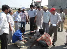 A team of Vigilance Bureau collecting samples of the construction done on a road in Moga on Friday.