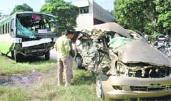 The mangled remains of the Toyota Innova and the Punjab Roadways bus