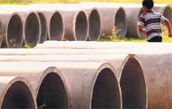A kid playfully makes his way through drainpipes to be laid in Sector 56, Chandigarh