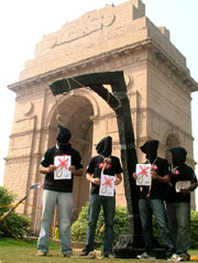 Activists of Amnesty International India wear black hoods and nooses around their necks, as they protest against death penalty in New Delhi on Friday.