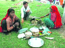 A poor family makes food after work on the roadside in Ambala on Friday.
