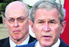 George W. Bush seen with treasury secretary Henry Paulson in Washington on Saturday.