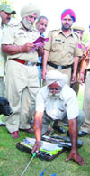 A police team checks the abandoned briefcase found outside a hotel in Amritsar on Saturday.