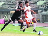 Balwant Singh (R) of JCT in action during the ONGC I-League match against Mohammedan Sporting in Ludhiana on Saturday.