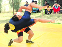 A bout in progress during Punjabi University Inter-College Wrestling Championship at Patiala.