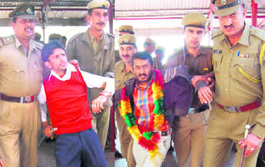Police personnel take away agitating PTA teachers to the police station in Shimla on Sunday.