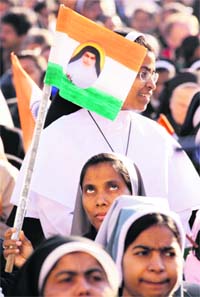 A nun waves a flag printed with a portrait of Sister Alphonsa of the Immaculate Conception as Pope Benedict XVI celebrated the canonisation ceremony in St. Peter square at the Vatican on Sunday. Pope gave the Roman Catholic church four new saints, including Sister Alphonsa.