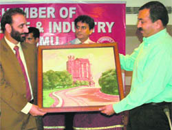 Jammu Divisional Commissioner Sudhanshu Pandey (right) presents a memento to Zulfiqar Abbasi, president of the PoK Chamber of Commerce, in Jammu on Sunday.