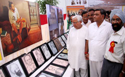 Minister for local bodies Manoranjan Kalia has a look at an exhibition held at the Public Library in Bathinda on Sunday.